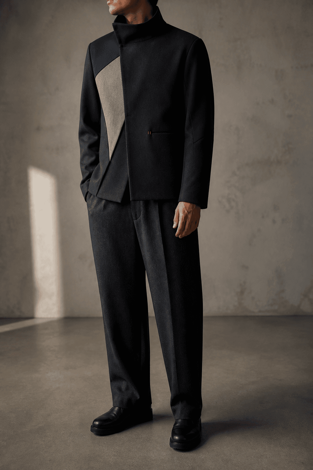 Man wearing the charcoal, midnight blue, and stone Parallax Jacket